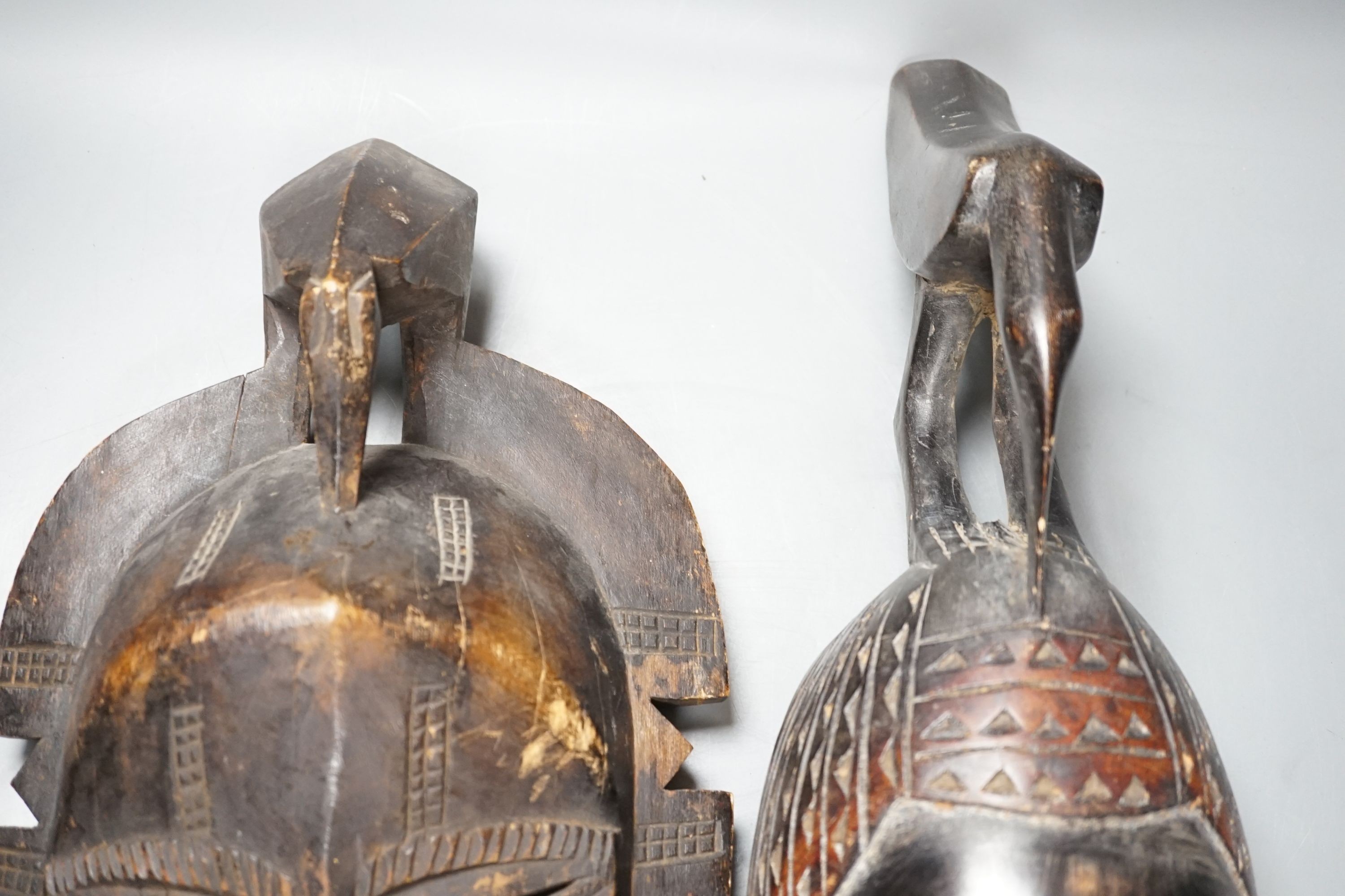 Two African carved wood masks; Senufo and Baule 65cm